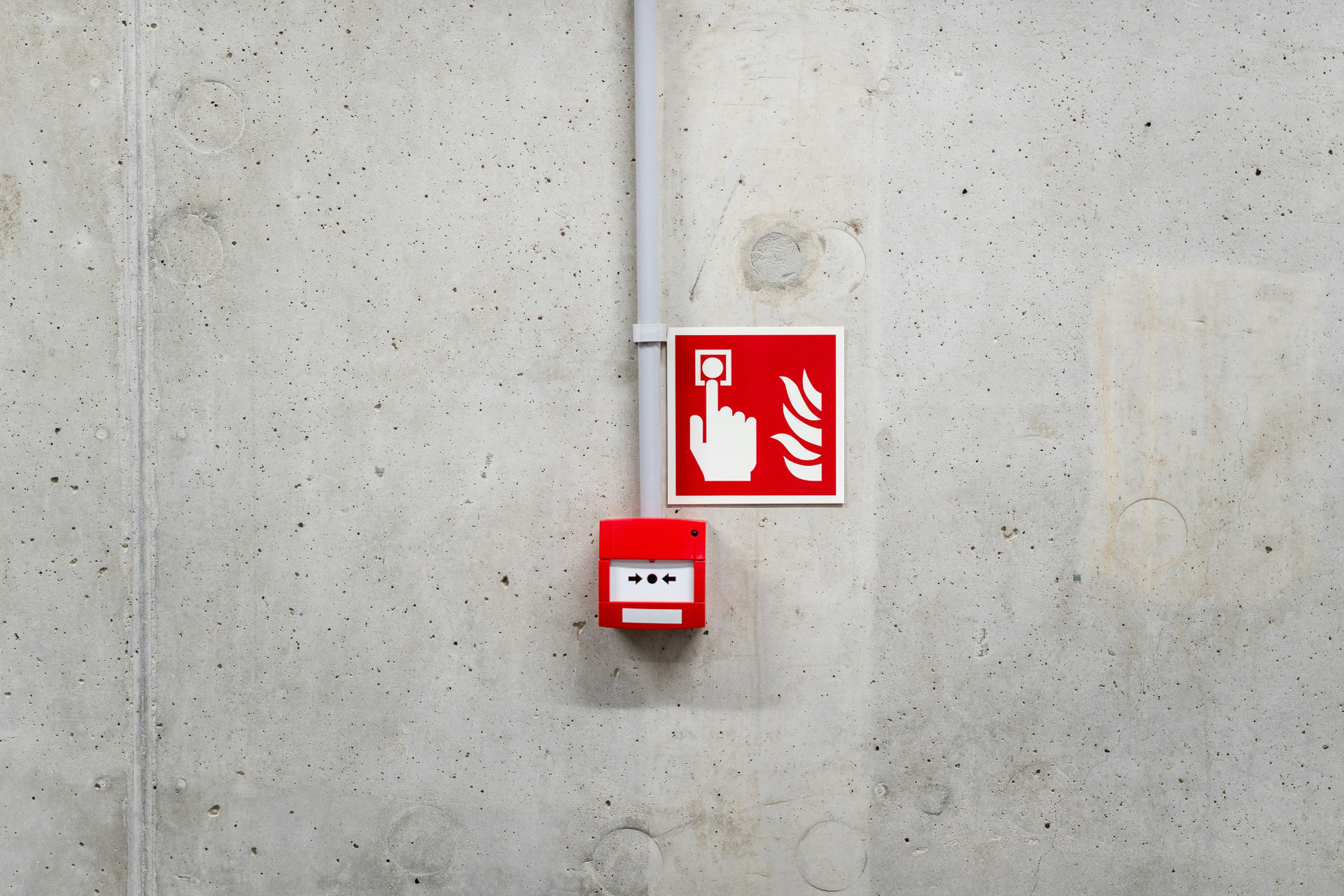 Fire alarm call point on a concrete wall